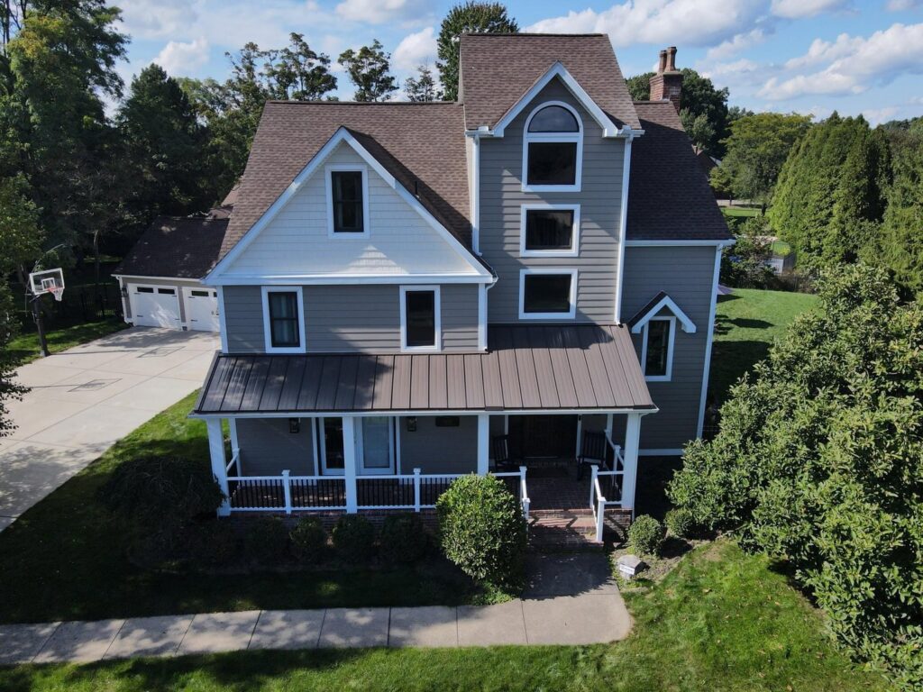 An aerial view of a large house featuring new light gray siding by My Guys Remodeling Experts in Bethel Park, PA.