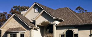 A large residential home featuring a combination of stucco and brick siding, a project by Urban Exteriors LLC in Lakewood, CO.