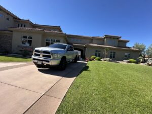 A large residential house with a sparkling clean driveway after service by Farki Pressure Washer LLC in Mesquite, NV