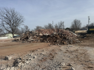 A large pile of concrete and brick demolition debris, a result of work by Enfield Demolition & Excavation LLC in Enid, OK.