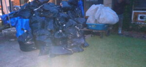 A large pile of black and white trash bags filled with demolition debris from HaysCo Facilities Management, Inc. in Dothan, AL.