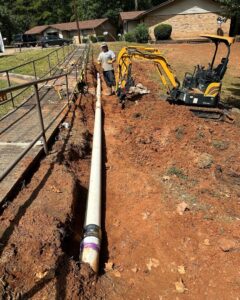 A large pipe being installed in a trench for water damage repair by Robert Brown Plumbing, LLC in Bossier City, LA.