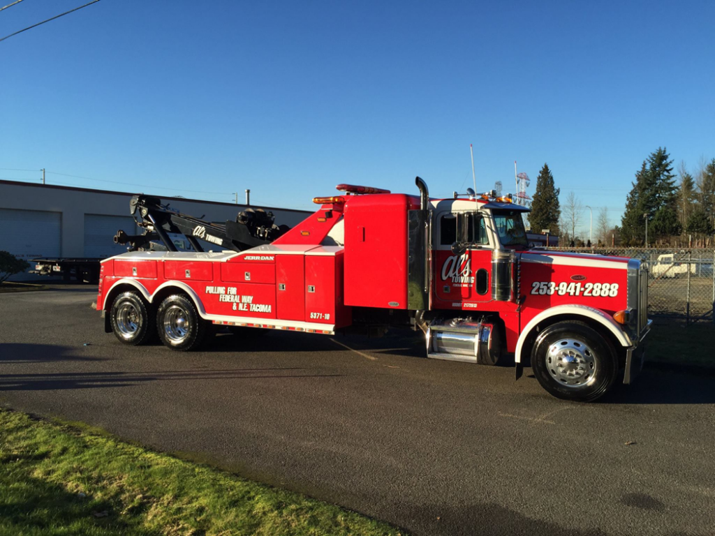 A large red and white wrecker tow truck from Al's Towing parked in Jackson, NJ