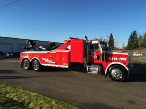 A large red and white wrecker tow truck from Al's Towing parked in Jackson, NJ
