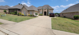 A large residential property with a well-kept lawn and landscaping, maintained by Caffey's Lawn Care LLC in Jackson, MS.