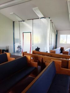 A large room with plastic sheeting set up for containment during a restoration project by Island Restoration LLC in Kapolei, HI.