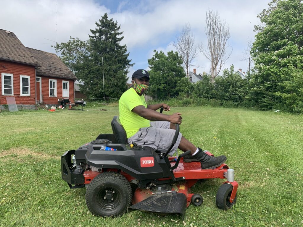 A large pile of cleared snow next to a building, indicating snow removal services by Knight's Landscaping & Snow Removal in Buffalo, NY.
