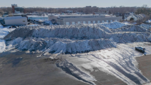 Large snow piles accumulated after a snow removal operation by the City of Cambridge Department of Public Works in Cambridge, MA.