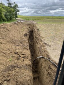 Installation of a large underground pipe, possibly a water main, by KD Services - Excavating in Bismarck, ND
