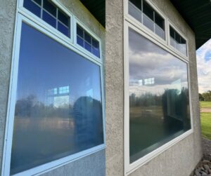 Before and after of a large residential window cleaned by Splash Pros Pressure Washing in Reno, NV.