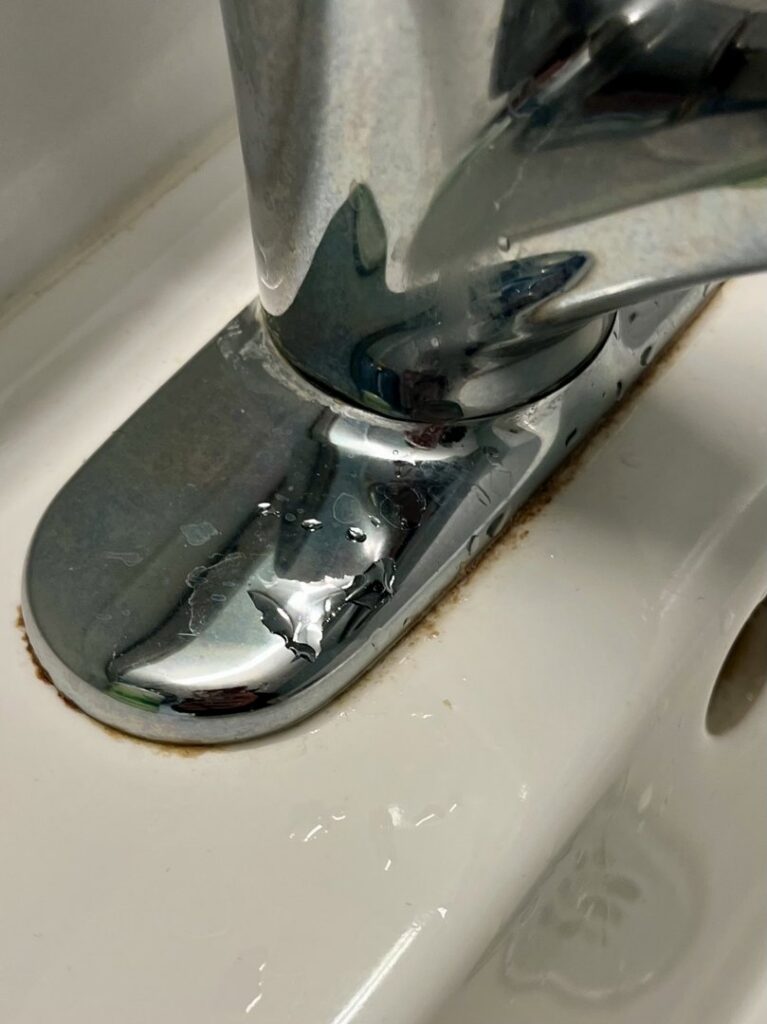 A close-up of a leaky faucet base with visible water stains and rust, indicating a water damage issue that Ciocca Cleaning & Restoration in Fort Wayne, IN can address.