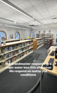 A library floor covered in water after a major water loss, being assessed by Clean Care of New England in Cranston, RI