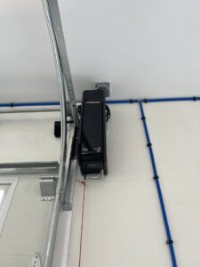A newly installed LiftMaster garage door opener and tracks by Douglas Garage Door Center in East Hartford, CT.
