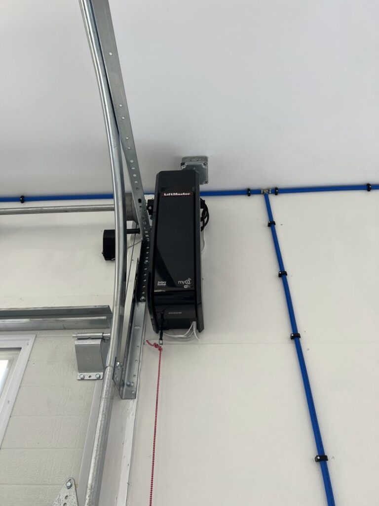 A newly installed LiftMaster garage door opener and tracks by Douglas Garage Door Center in East Hartford, CT.