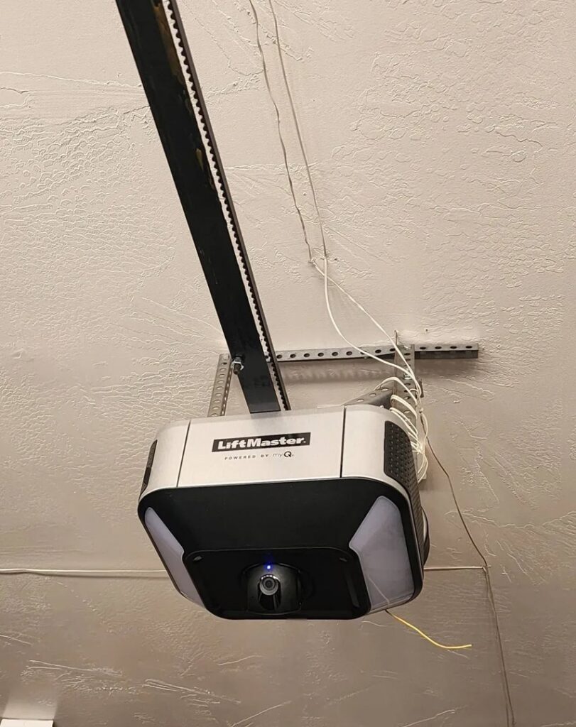 A LiftMaster garage door opener installed on a garage ceiling by Quality-Brand Garage Doors in Rio Rancho, NM.