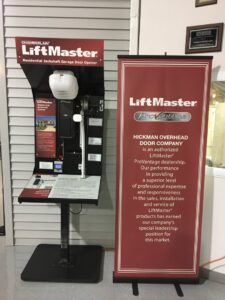 A LiftMaster residential jackshaft garage door opener display and company banner at Hickman Overhead Door in Milford, DE.