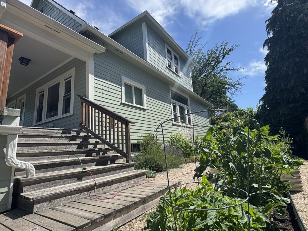 A light green house with horizontal and shake siding, a project by Lifetime Remodeling Systems in Portland, OR