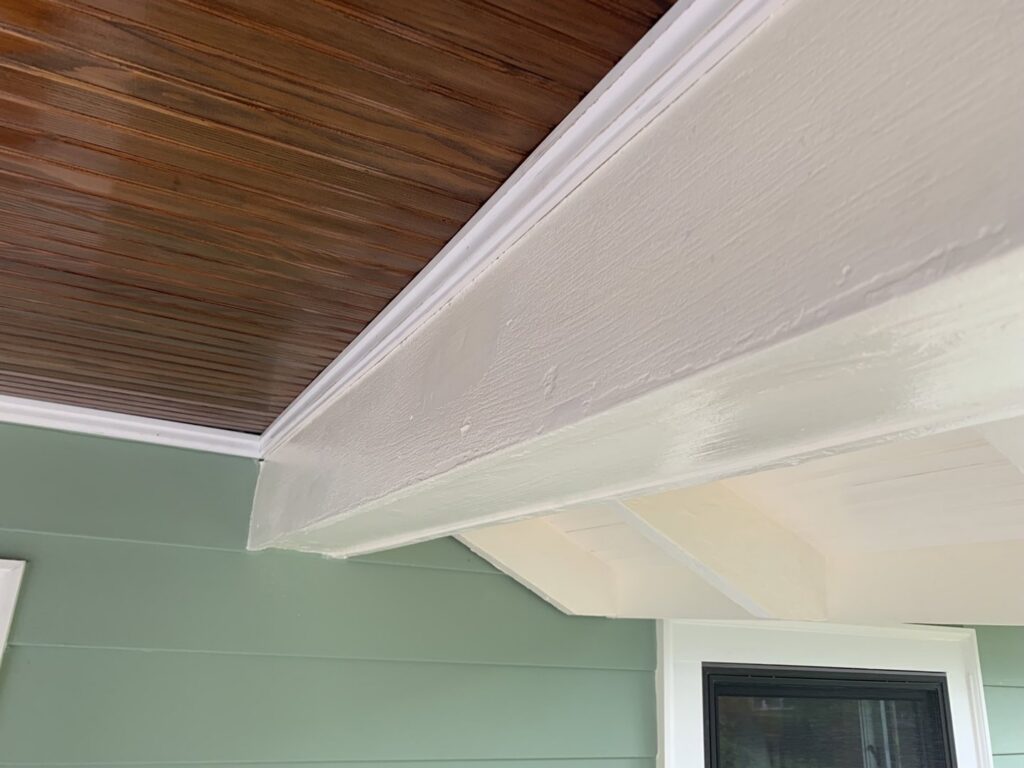 Close-up of newly installed light green siding and white trim on a house by Sosa Painting and Remodeling, LLC in Alexandria, VA.