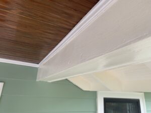 Close-up of newly installed light green siding and white trim on a house by Sosa Painting and Remodeling, LLC in Alexandria, VA.
