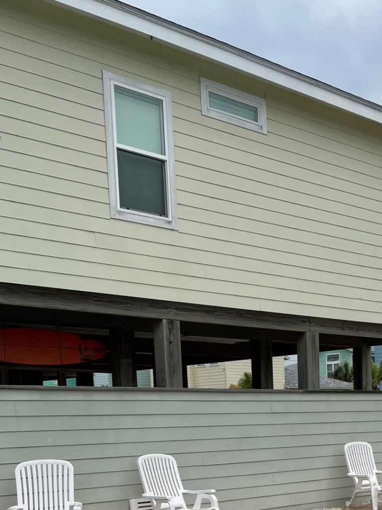 Completed light green horizontal siding on an elevated home by Corpus Christi Siding Pros, Corpus Christi, TX.