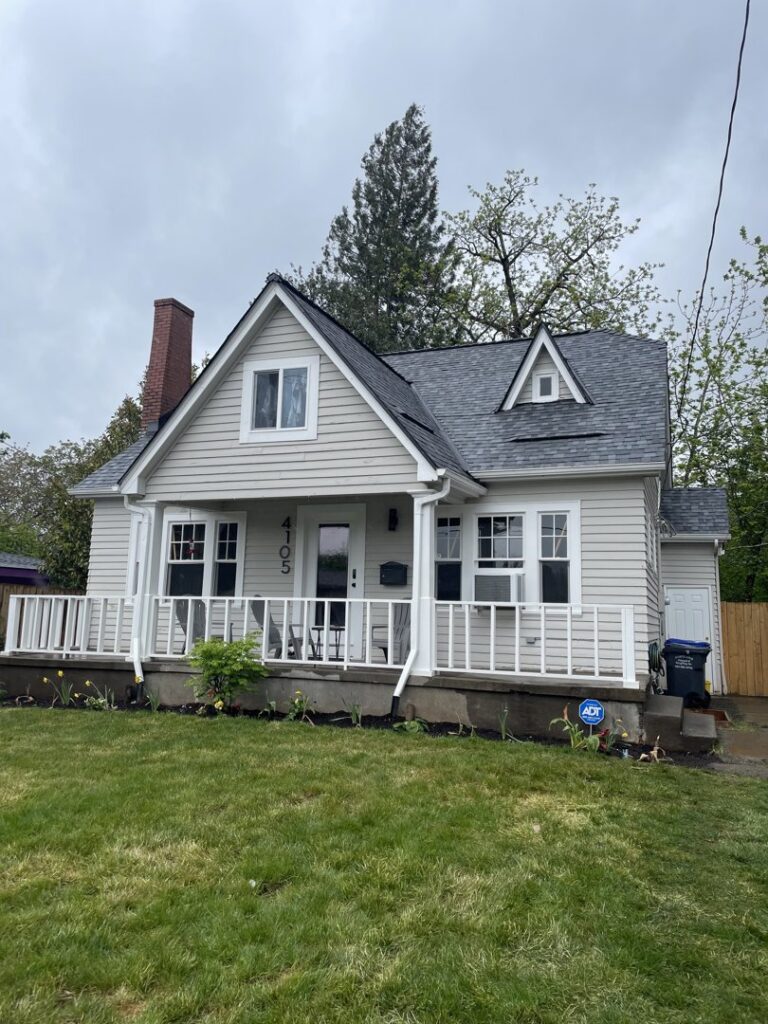 A small home with newly installed light grey siding by High Performance Homes in Vancouver, WA