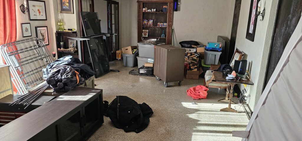 A living room filled with packed moving boxes and furniture, indicating a move in progress by Top Notch Movers in Madison, WI.