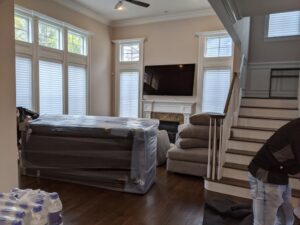 A living room with large furniture items professionally wrapped and ready for moving by Packsen Moving in San Antonio, TX.