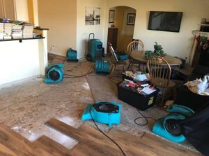 Living room with removed flooring and drying equipment for water damage by Complete Restoration and Construction, LLC in Yakima, WA
