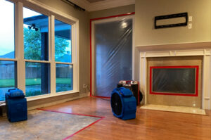 Living room with water damage drying equipment and containment by 1st Response Emergency Repairs, LLC in Scott, LA.