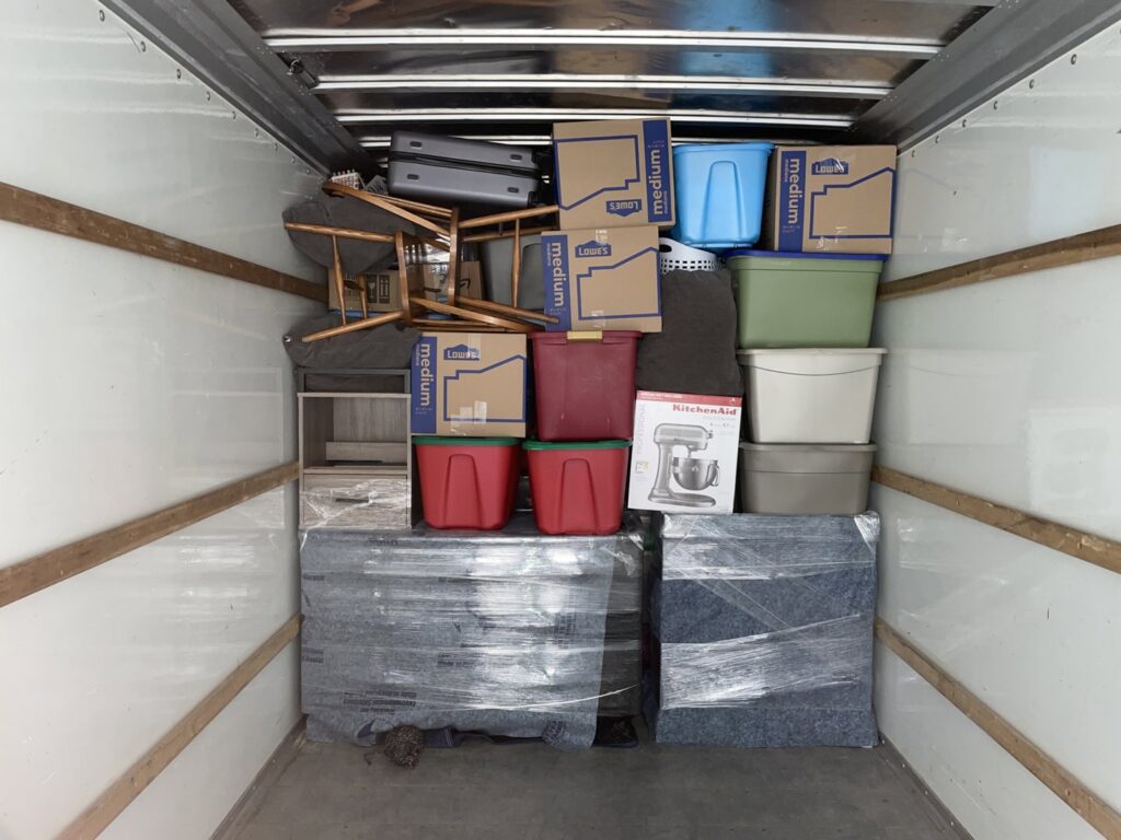 The interior of a moving truck fully loaded with wrapped furniture and boxes by Shield Moving Services in Milwaukee, WI.