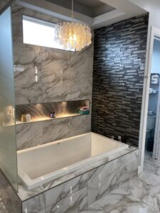 A luxurious and immaculately clean bathroom with a large bathtub and stylish tile work, cleaned by Inspire Clean OKC in Oklahoma City, OK.