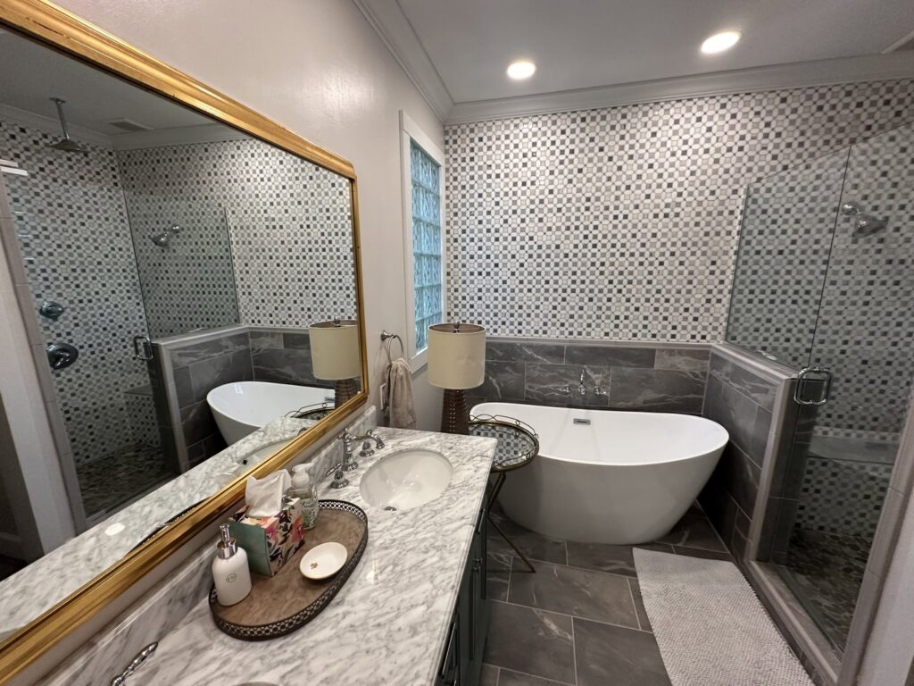 A luxurious and clean bathroom with a freestanding tub and glass shower, professionally tidied by Top-Notch Tidy Services in Chesapeake, VA.