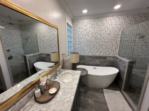 A luxurious and clean bathroom with a freestanding tub and glass shower, professionally tidied by Top-Notch Tidy Services in Chesapeake, VA.