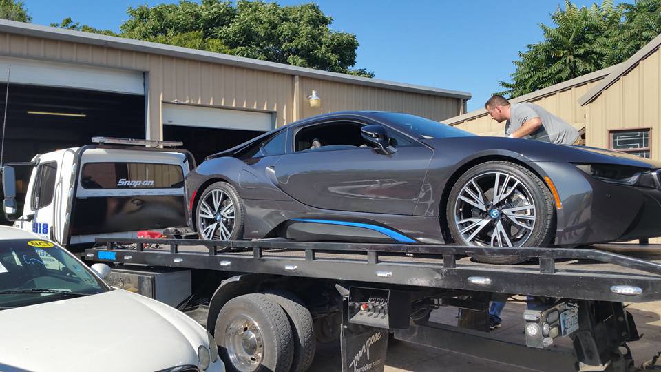 A luxury sports car being transported on a flatbed tow truck by 918 Wrecker Service in Tulsa, OK.