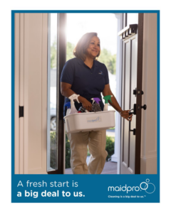A MaidPro Wichita cleaner arriving at a client's home with a caddy of cleaning supplies in Wichita, KS.