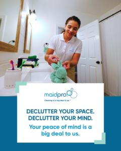 A MaidPro Wichita cleaner folding a towel in a client's bathroom, showing attention to detail in Wichita, KS.