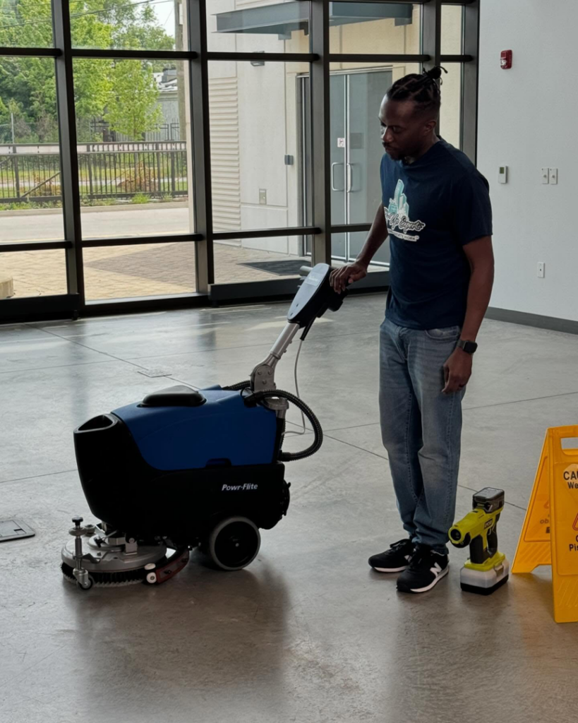 A man operating a professional floor scrubber machine for Tidy Up Experts LLC in Chicago, IL.