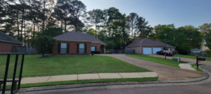 A manicured front yard of a residential home, demonstrating the quality lawn care services of Caffey's Lawn Care LLC in Jackson, MS.
