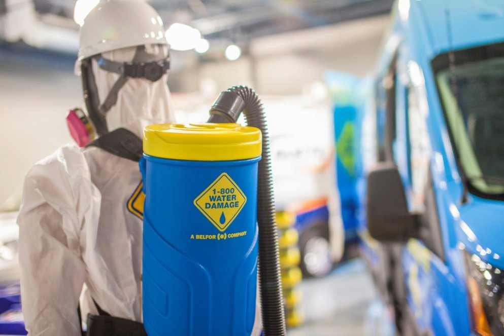 A mannequin in a hazmat suit with a backpack sprayer, representing safety protocols for 1-800 WATER DAMAGE of Oklahoma City, OK.