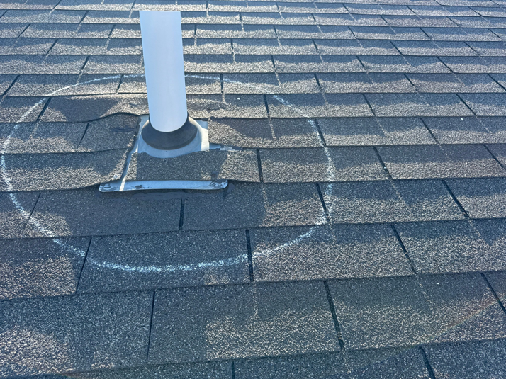 A roof vent pipe with a chalk circle marking a potential leak source for Sharp Restoration in Lincoln, NE.