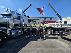 The McDowell Wrecker Service team stands proudly with their heavy-duty tow trucks in Springfield, MO.