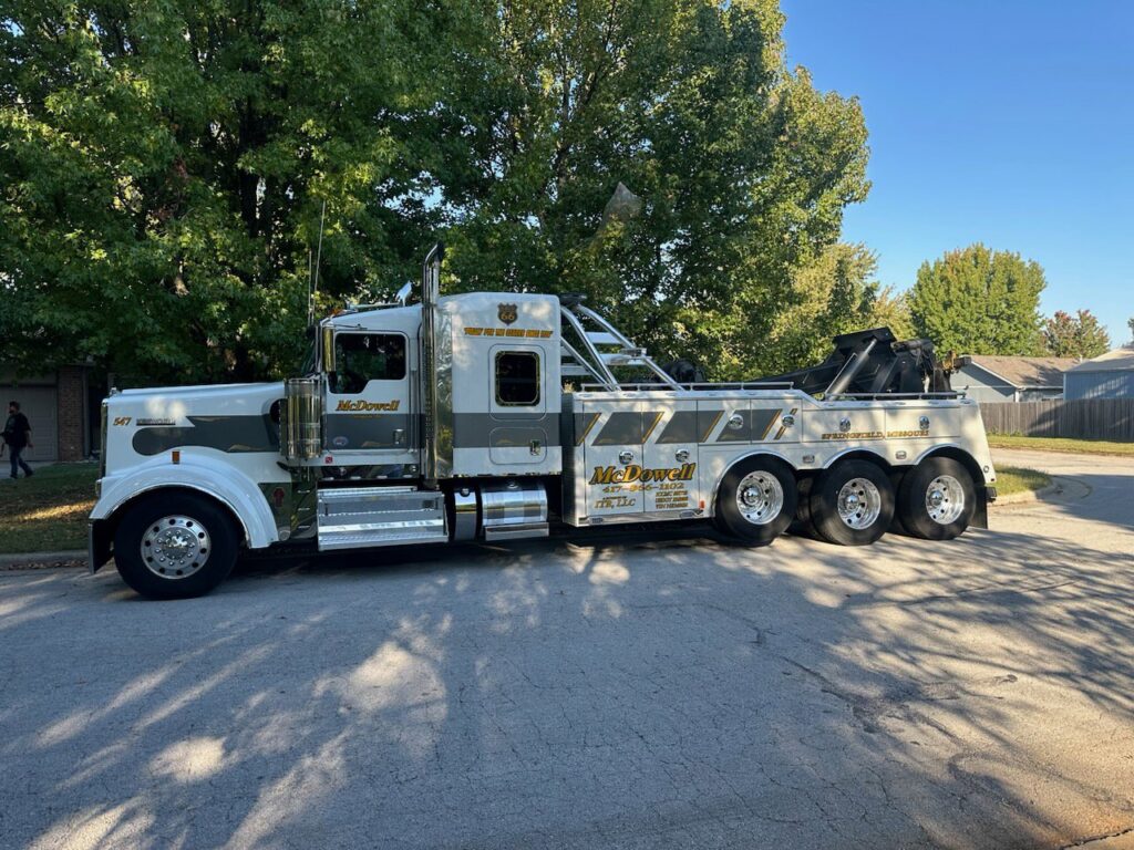 A McDowell Wrecker Service heavy-duty tow truck parked on a residential street in Springfield, MO.