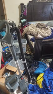 A messy bedroom with clothes on the bed and floor, showing a before-cleaning scene by Cleaning with Lisseth in Madison, WI.