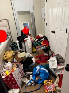 A very messy bedroom with clothes and items on the floor, representing a 'before' scene for house cleaning by BMC Cleaning Services in Sugar Land, TX.