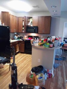 A messy kitchen with cleaning supplies, ready for service from Nicoles Cleaning Service LLC in Mobile, AL.
