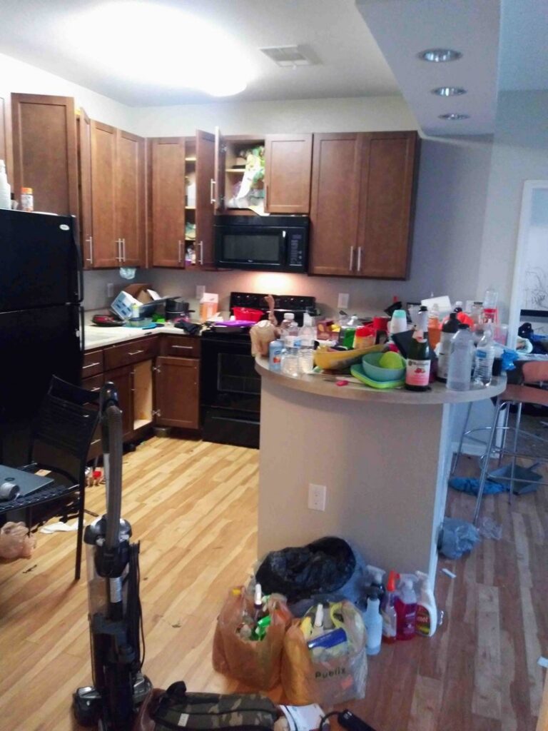A messy kitchen with cleaning supplies, ready for service from Nicoles Cleaning Service LLC in Mobile, AL.