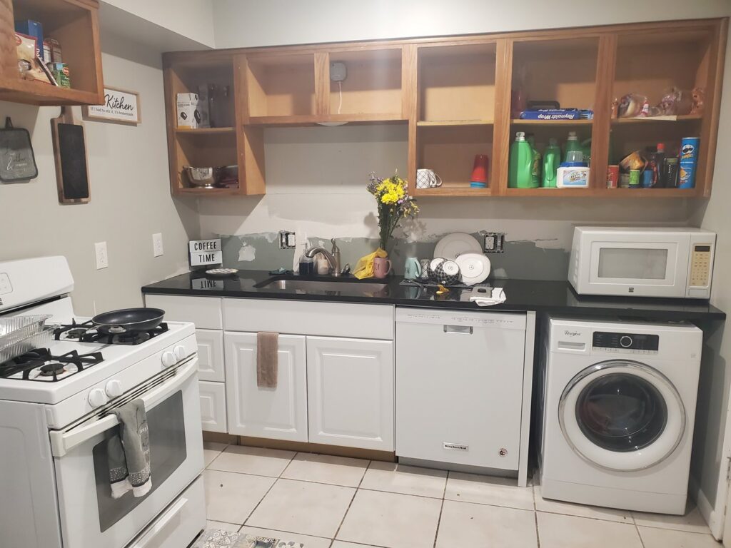 A messy kitchen with dishes in the sink, showing a 'before' scenario for house cleaning by Perfection Cleaning in Kansas City, MO.