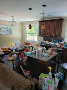 A very messy kitchen and dining area, showing a space ready for cleaning by Evelyn's Cleaning Services in Huntsville, AL.