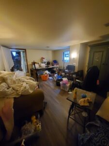 A cluttered and messy living room before professional cleaning by Chelle's Cleaning Services in Gary, IN.