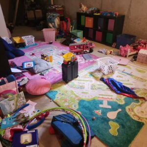 A messy playroom with toys scattered on the floor, awaiting cleaning by Brighter Days Cleaning in Sacramento, CA